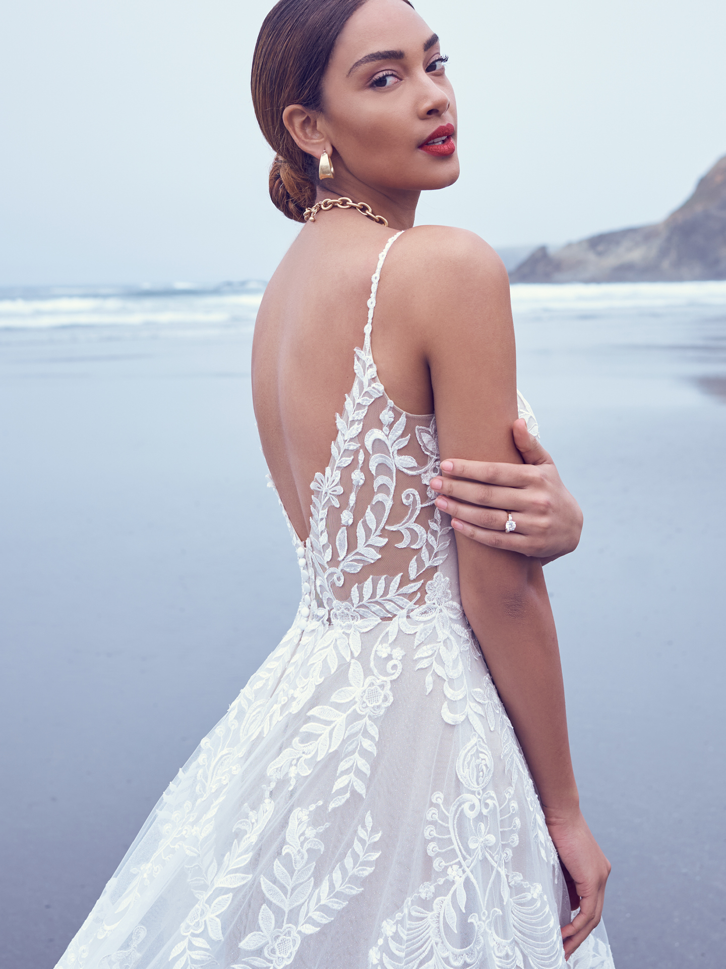 Mariée portant une robe de mariée A-ligne en dentelle bohème sur la plage appelée Brooklyn Sottero et Midgley