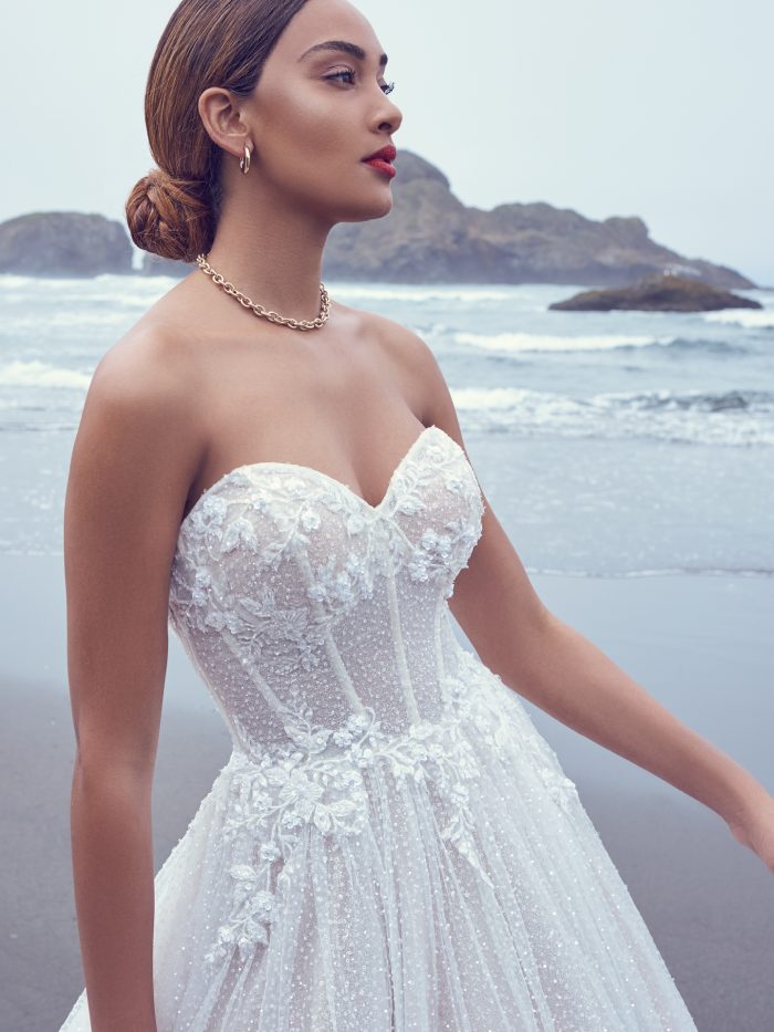 Bride Wearing One Of Our Unique Wedding Dresses While Walking On A Beach Called Shasta By Sottero And Midgley