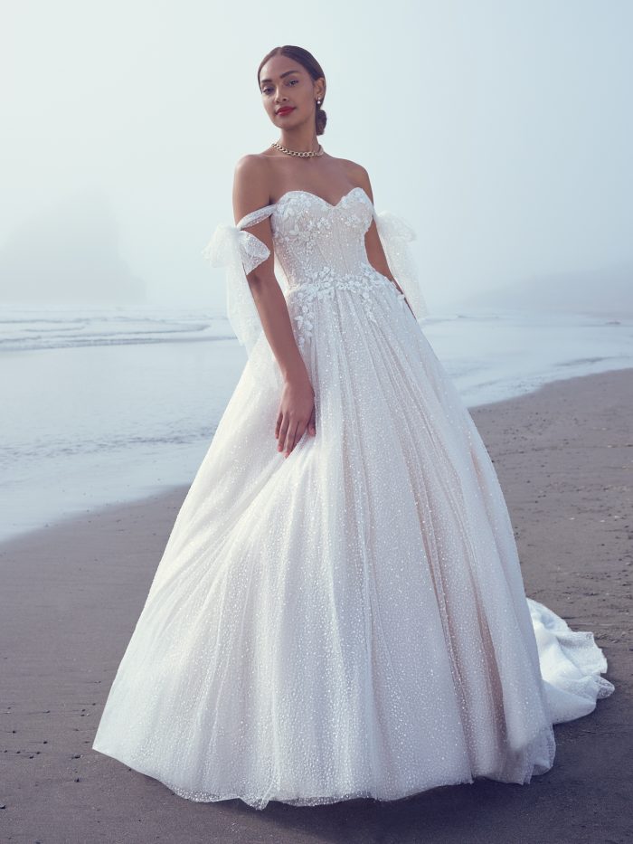 Bride Wearing One Of Our Unique Wedding Dresses While Walking On A Beach Called Shasta By Sottero And Midgley