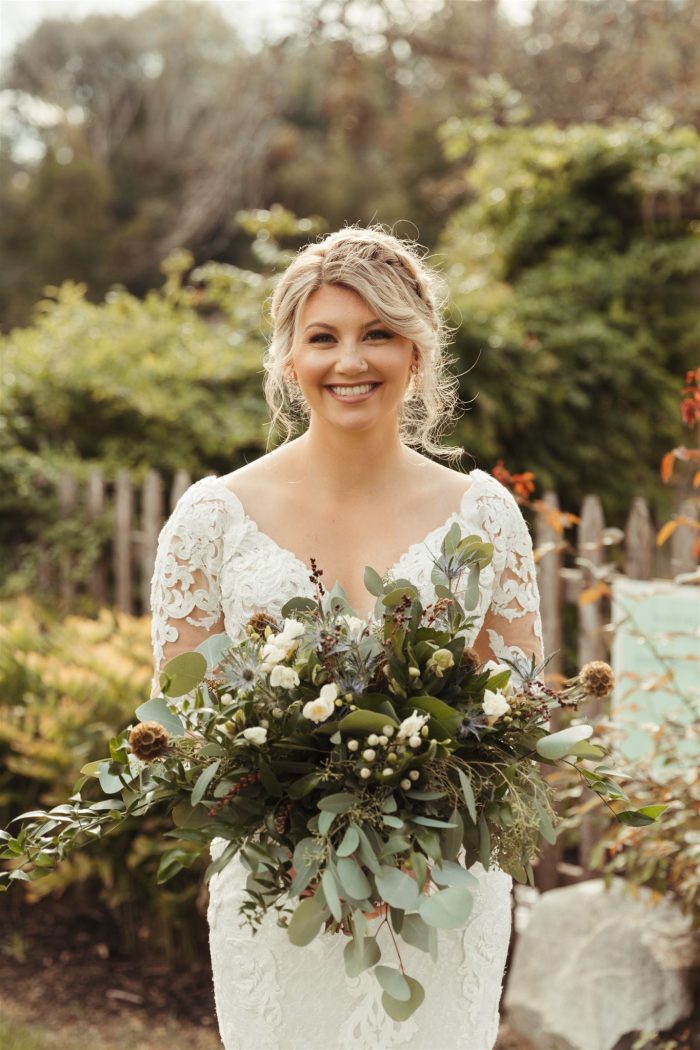 Bride In Long Sleeve Wedding Dress Called Tuscany Royale By Maggie Sottero With Bouquet