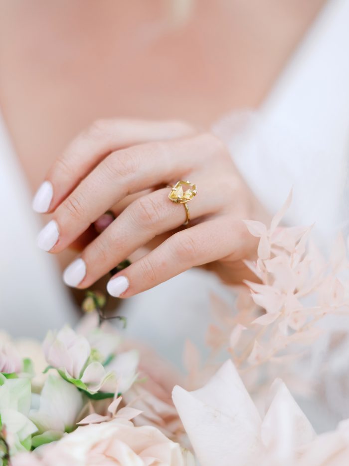 Engagement Ring On Ring Finger With Manicured Nails And Flowers