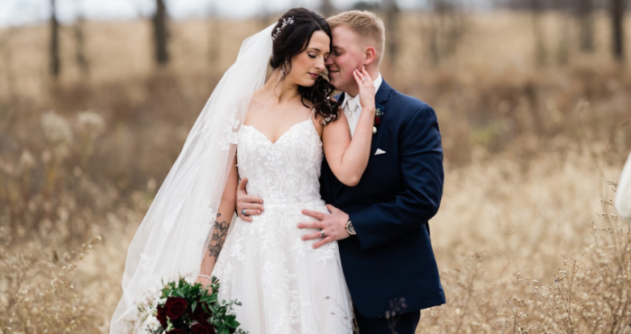 Bride wearing a fall wedding dress by Maggie Sottero with her husband