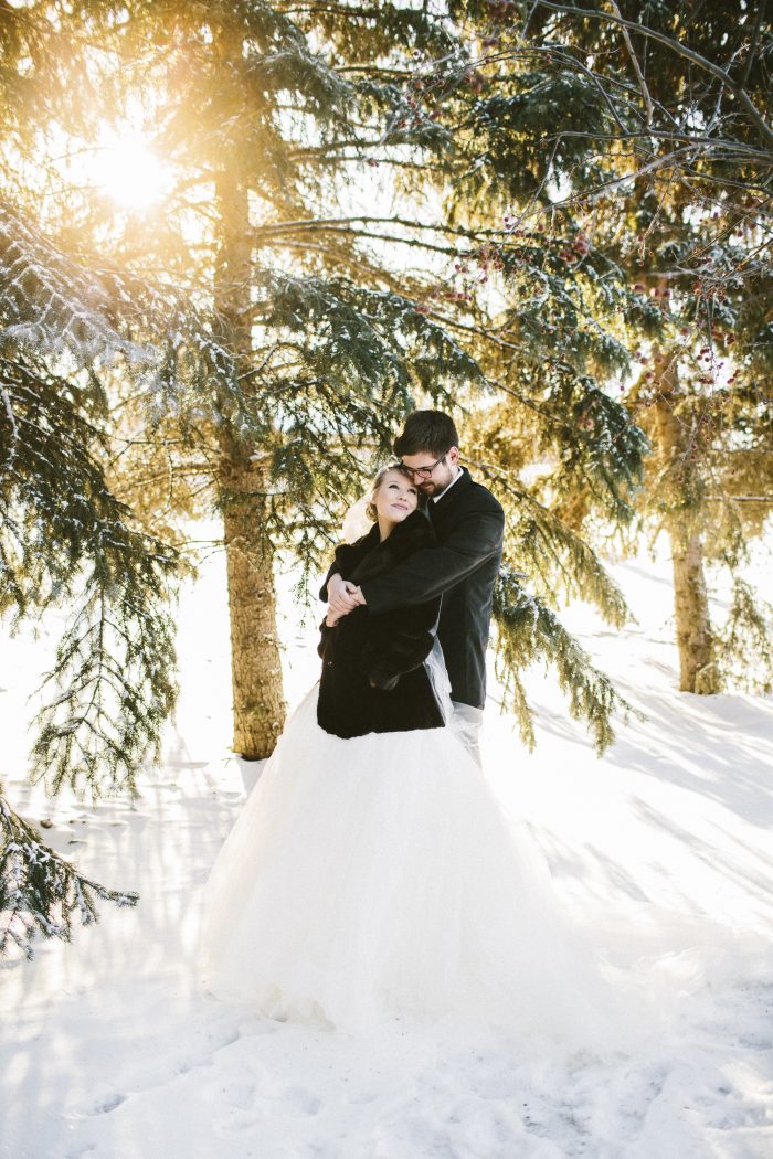 Bride And Groom Standing In Snow