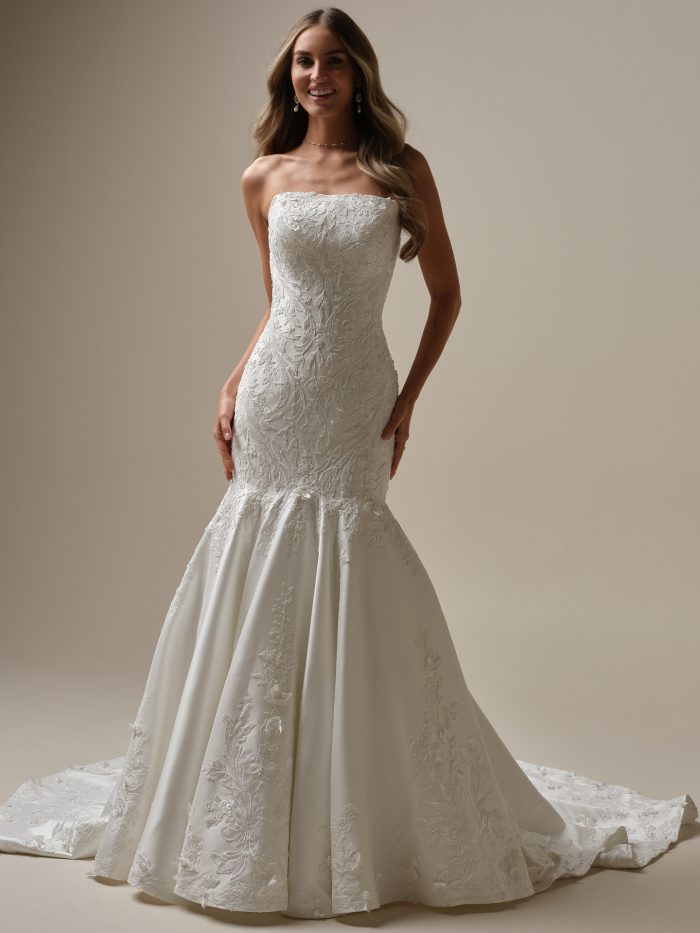 Bride wearing the Delanie fit-and-flare wedding dress with a strapless straight neckline, beaded lace bodice, and sculpted mermaid silhouette.