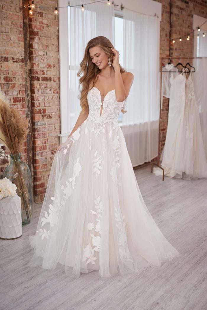 Bride Wearing A Romantic Wedding Dress Called Hattie Lane Marie By Rebecca Ingram With Plunging Neckline And Floral Lace