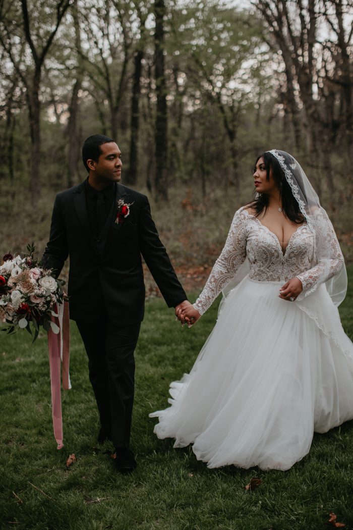 Asian Bride In Long Sleeved Wedding Gown Called Mallory Dawn By Maggie Sottero Walking With Black Husband