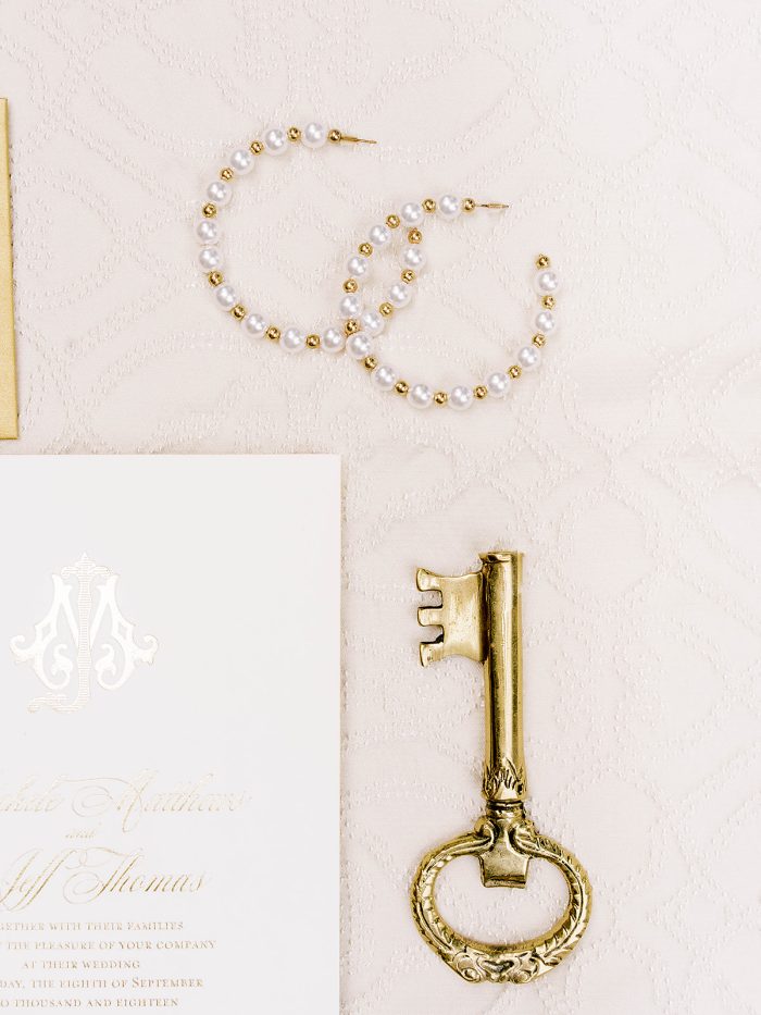 Photo Of Wedding Pearls With Pearl Earrings With Brass Key And Wedding Invitation