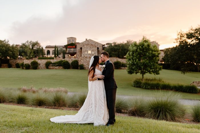 Bride And Groom Getting Married At A Vineyard With Bride Wearing Roxanne By Sottero And Midgley