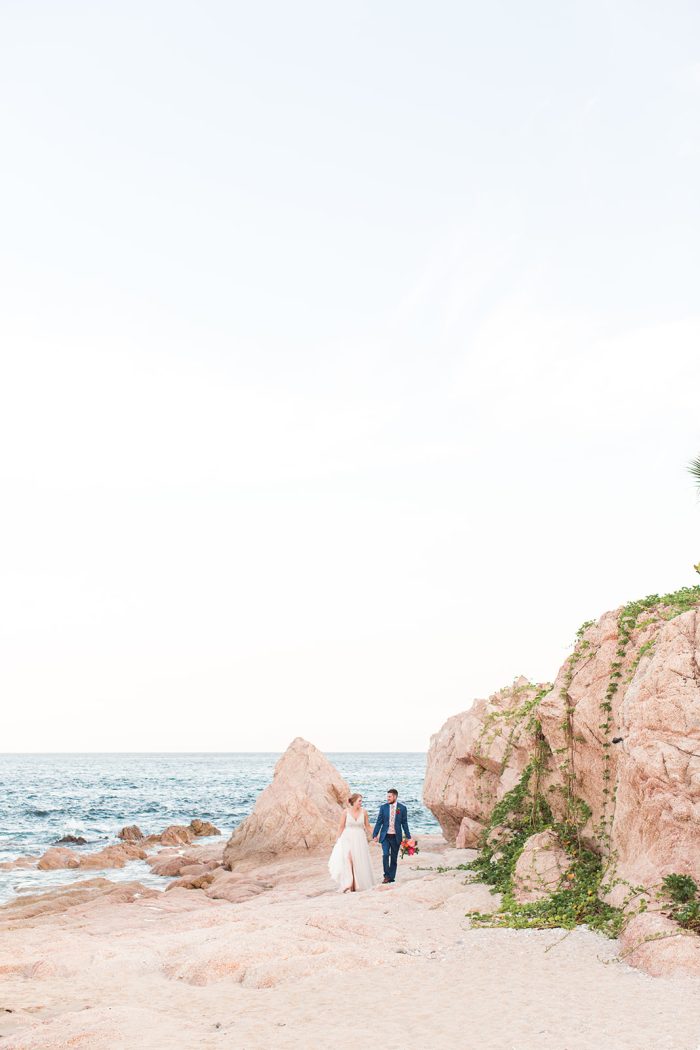 Wedding Venue Ideas Of Having A Seaside Wedding With A Bride And Groom Walking On The Beach With Bride Wearing A Dress Called Charlene By Maggie Sottero