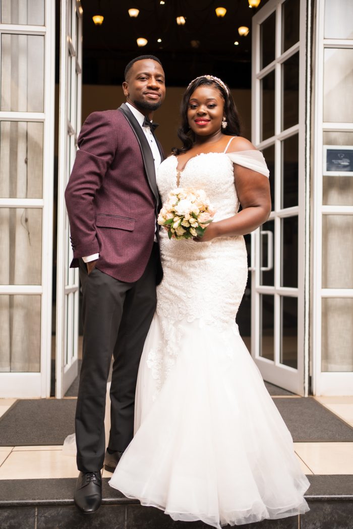 African Couple Standing Together At Their Wedding With Black Bride Wearing A Mermaid Wedding Dress Called Alistaire Lynette By Maggie Sottero