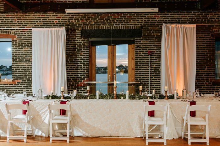 Swanky Hotel Wedding Venue Idea With White Linens And Brick Wall