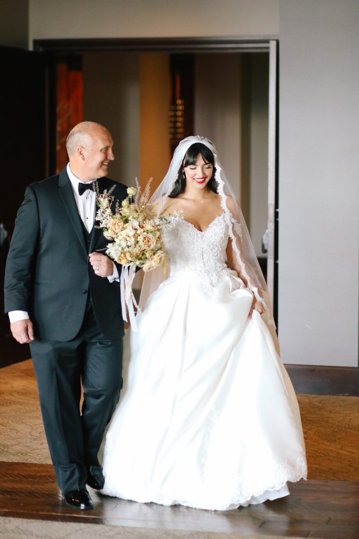 Bride Wearing NYC Wedding Dress Called Kimora By Sottero And Midgley Walking Down Aisle With Father 