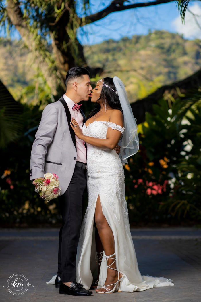 Bride Wearing Sexy Wedding Dress Called Frederique By Maggie Sottero With Groom In Dove Gray Suit With Bouquet