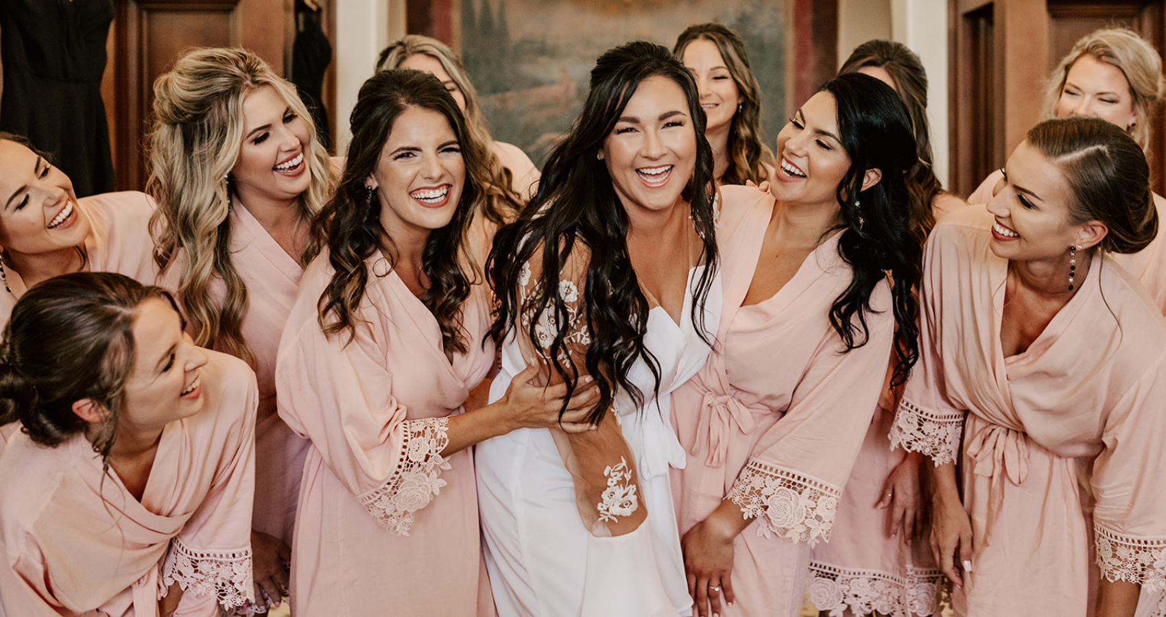 Photo Of A Bride With Her Bridesmaids Wearing Matching Pink Robes For The Blog Header Image For The Best Bachelorette Party Ideas Blog From Maggie Sottero Designs