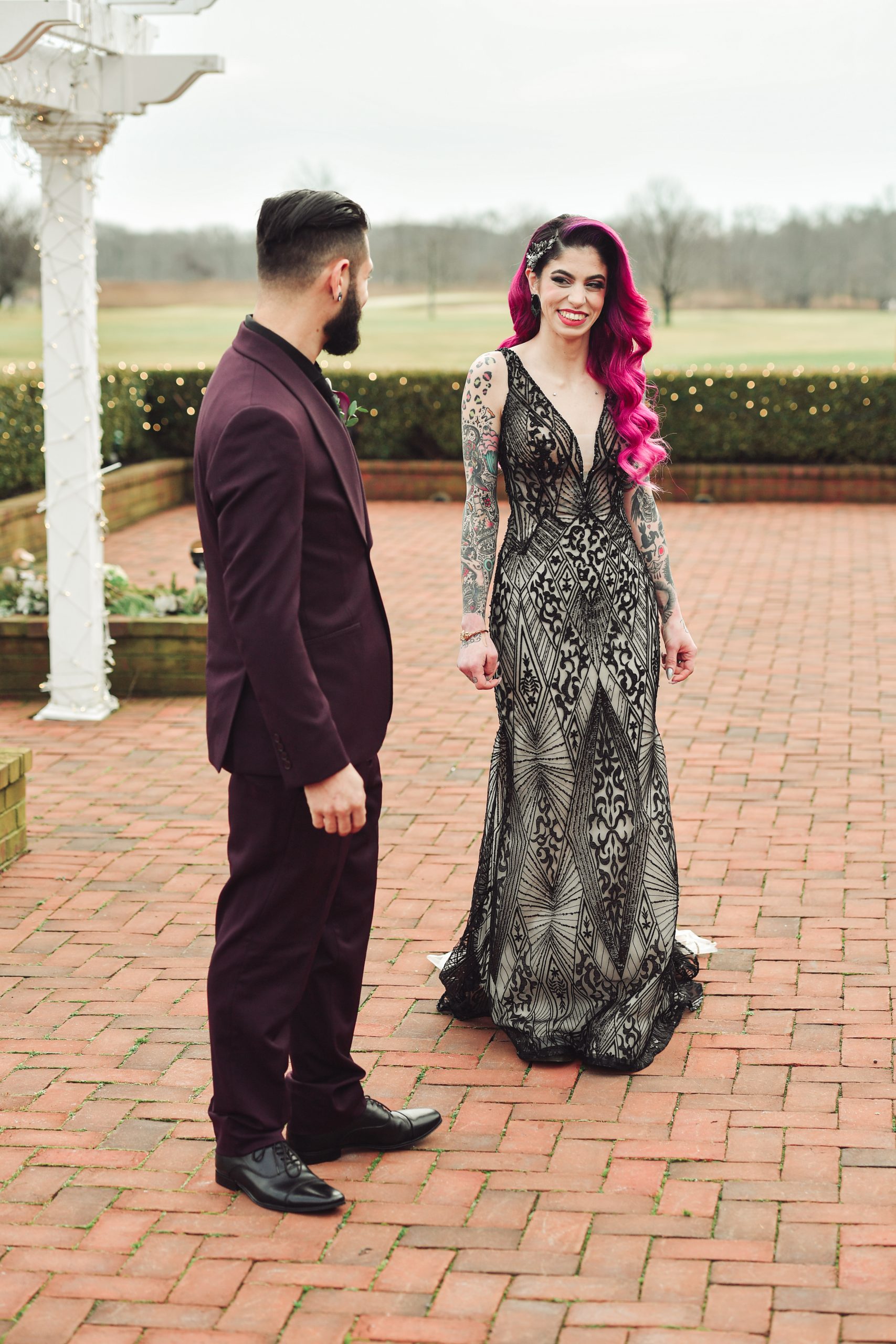Bride With Pink Hair Wearing Sexy Black Wedding Dress Called Elaine By Maggie Sottero With Husband In Burgundy Suit