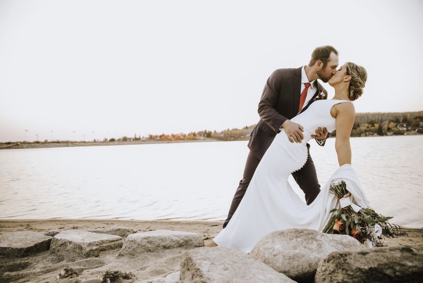 Bride Wearing Simple Crepe Wedding Gown Called Fernanda By Maggie Sottero With Groom By River