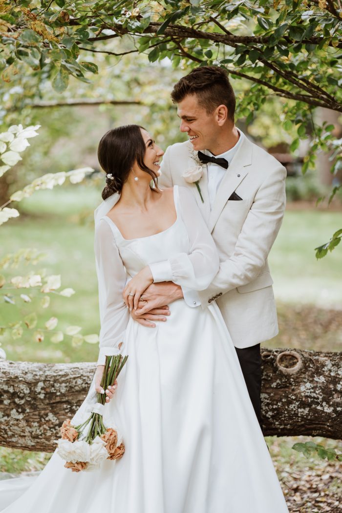 Bride Wearing A-Line Satin Wedding Dress With Puff Chiffon Sleeves Called Selena By Maggie Sottero With Groom