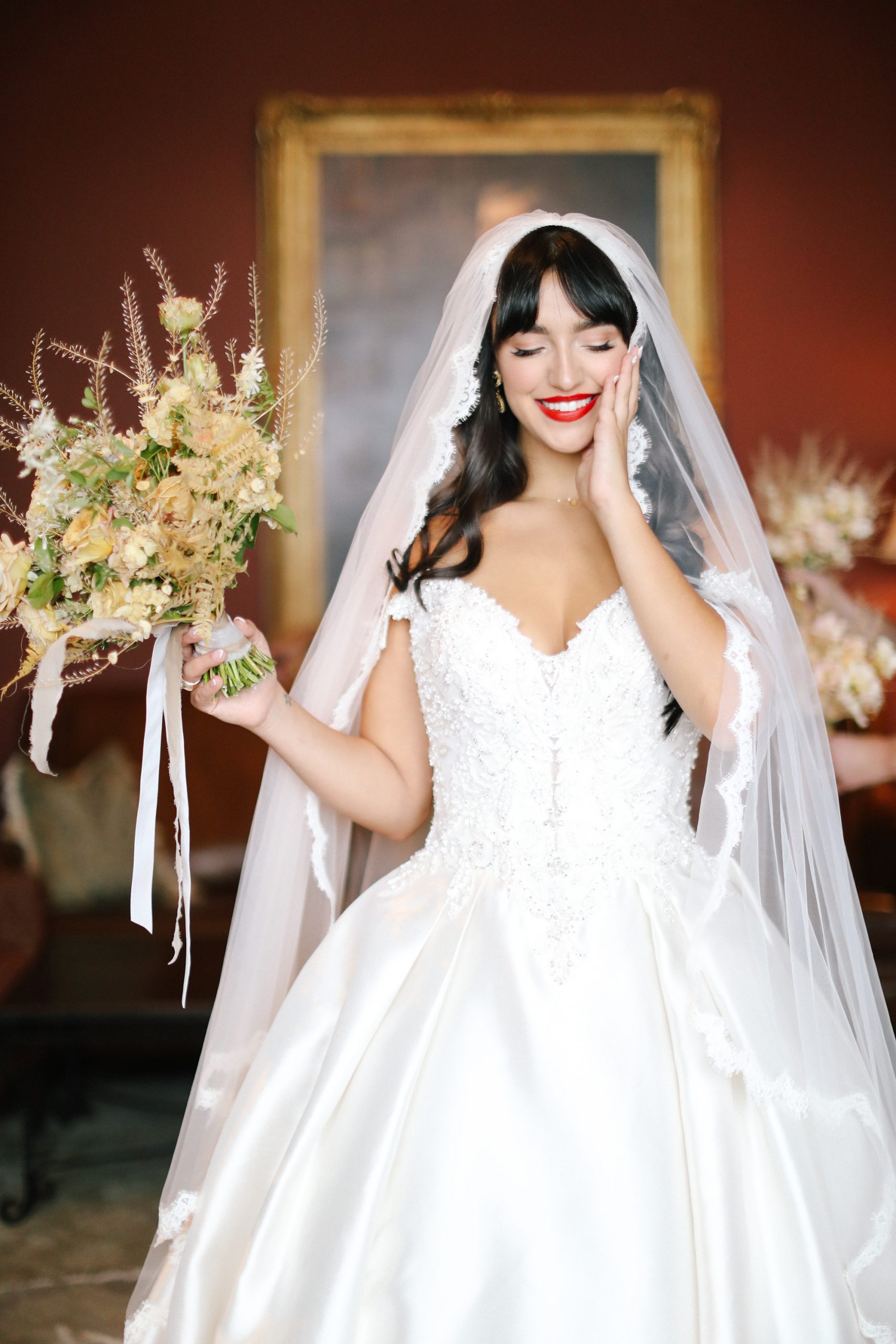 Mariée avec un look de maquillage classique et une frange de rideau portant une robe de mariée classique appelée Kimora par Sottero et Midgley