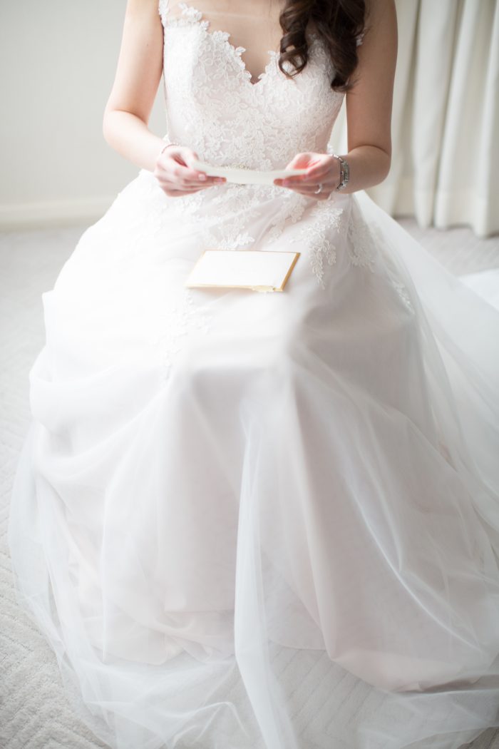 Bride Wearing An A-Line Wedding Dress Called Olivia By Rebecca Ingram Practicing Her Vows