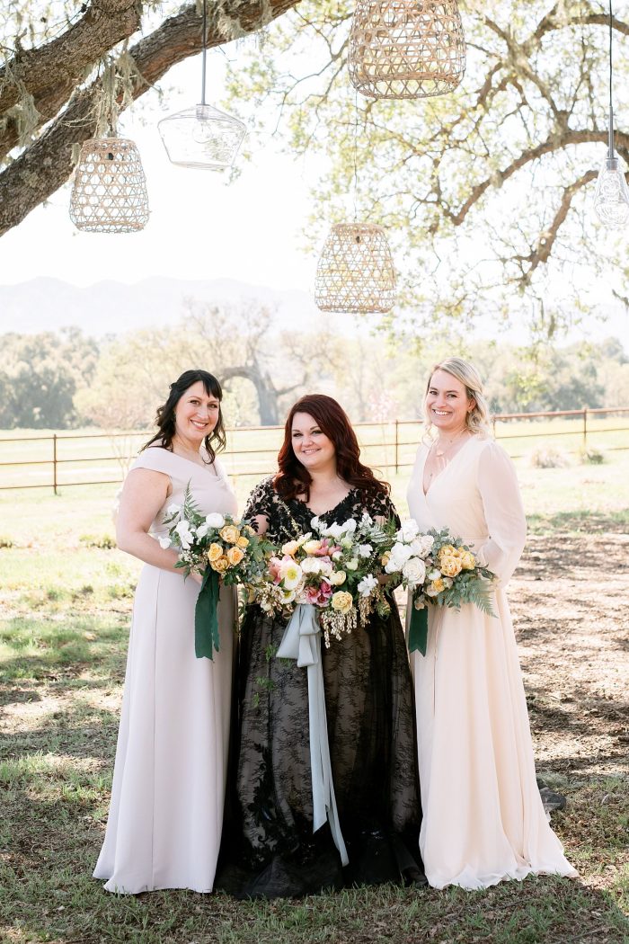Bride With Bridesmaids Wearing Light Pink Gowns Wearing A Black Wedding Dress Called Zander By Sottero And Midgley