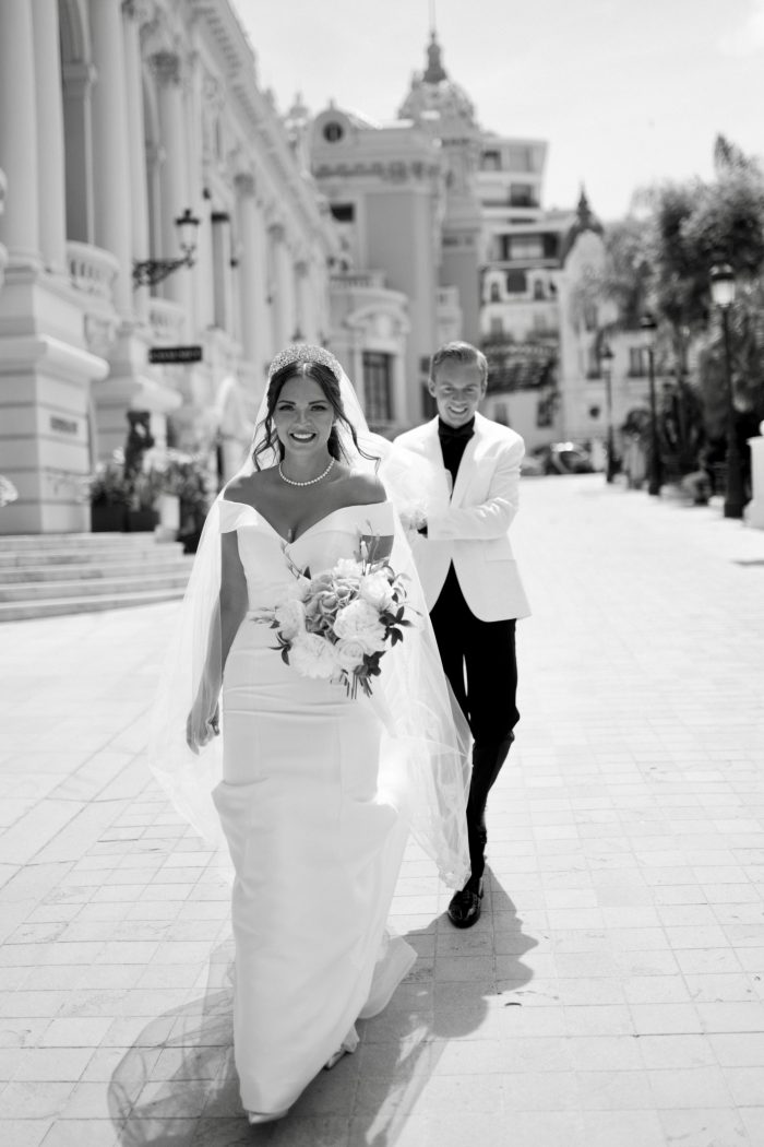 Black And White Photo Of Bride Wearing A Wedding Dress Called Josie By Rebecca Ingram with Veil And Groom