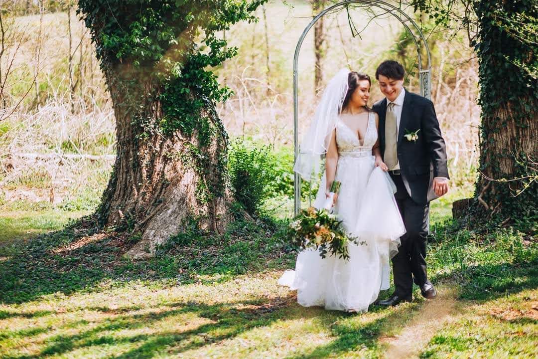 Bride Wearing An A-Line Floral Wedding Dress Called Raelynn By Rebecca Ingram With Groom