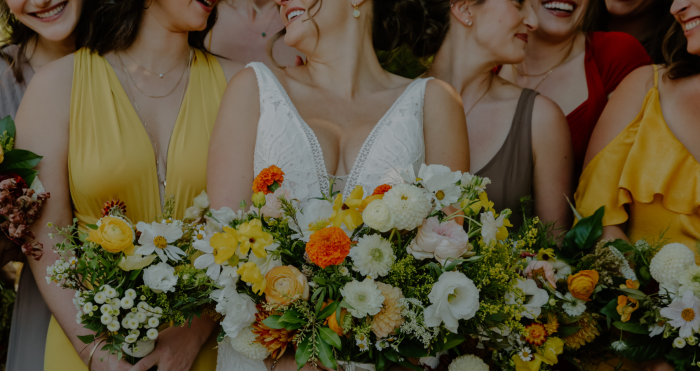Bride Wearing A Summer Wedding Dress Called Burke By Maggie Sottero With Bridesmaids In Yellow And Green With Flowers