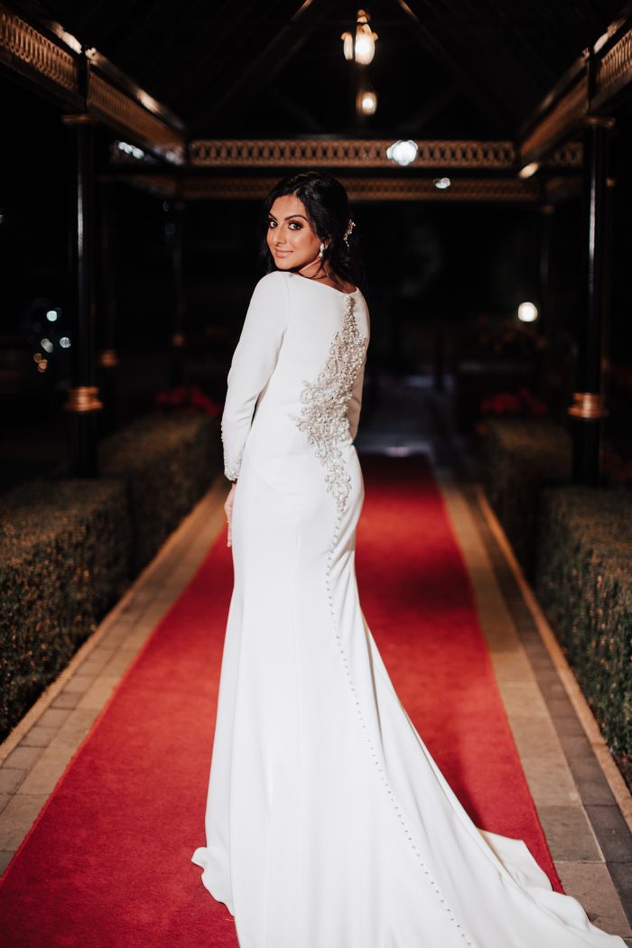 Bride In Long Sleeve Wedding Dress With Unique Back Called Aston By Sottero And Midgley