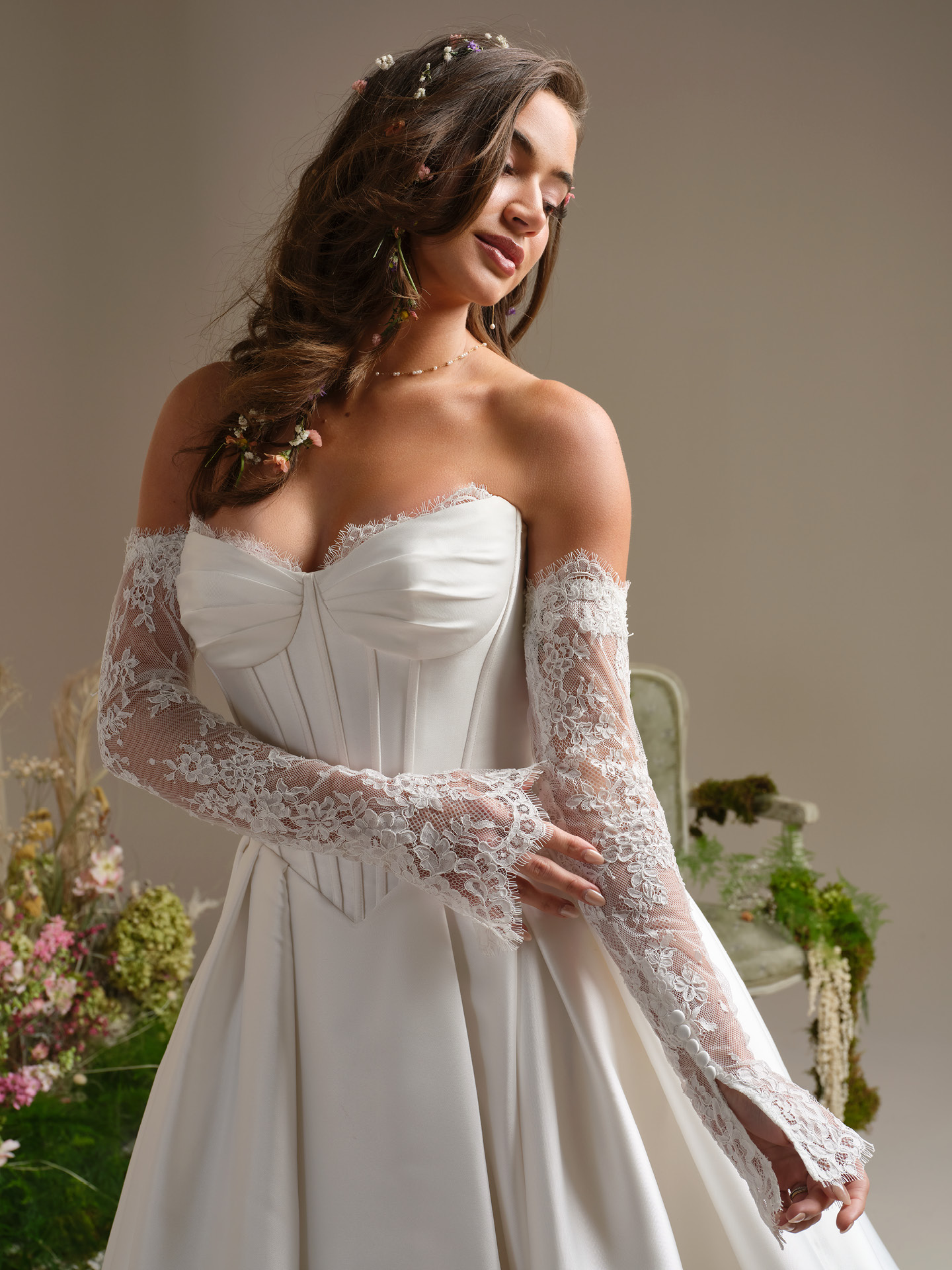 Rebecca Ingram Zorina wedding dress close-up of ruched sweetheart bodice with corset structure and delicate lace off-the-shoulder sleeves, highlighting a soft, feminine and elegant silhouette