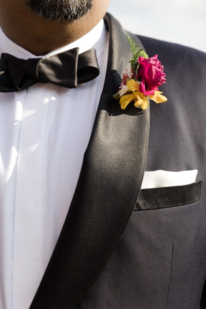 Groom In Black Suit With Magenta Flower