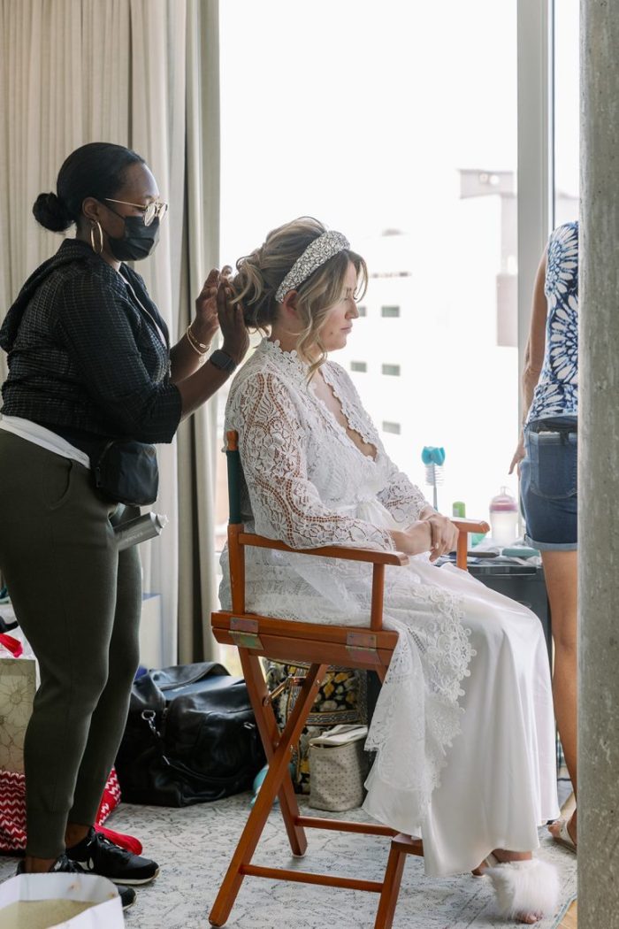 Bride getting her hair done while focusing on her mental wellness tips