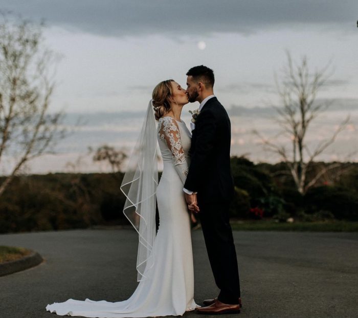 Bride In Long Sleeve Crepe Wedding Dress Called Bethany By Rebecca Ingram With Groom