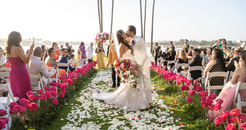 Bride In Barbiecore Wedding Dress With Pink Accents And Groom