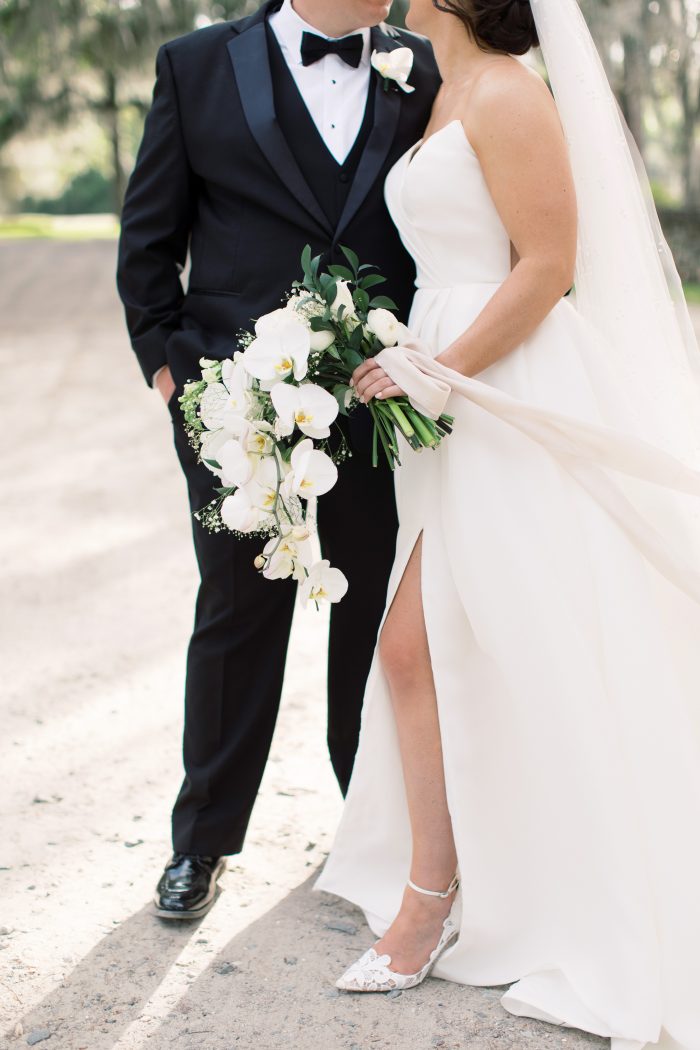 Bride wearing Nisha by Maggie Sottero standing with her husband