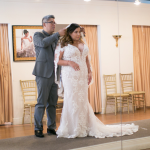 Bride Trying On Wedding Dresses At Trunk Show