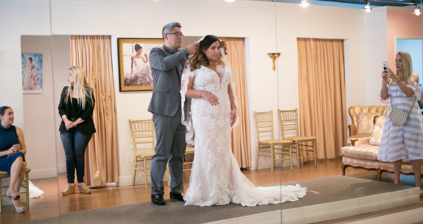 Bride Trying On Wedding Dresses At Trunk Show