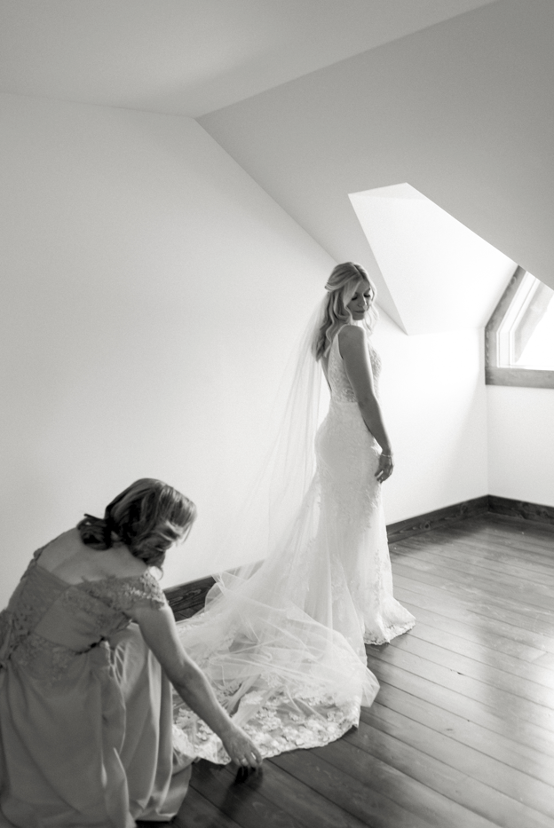 Bride's Friend Fixing Wedding Dress Train