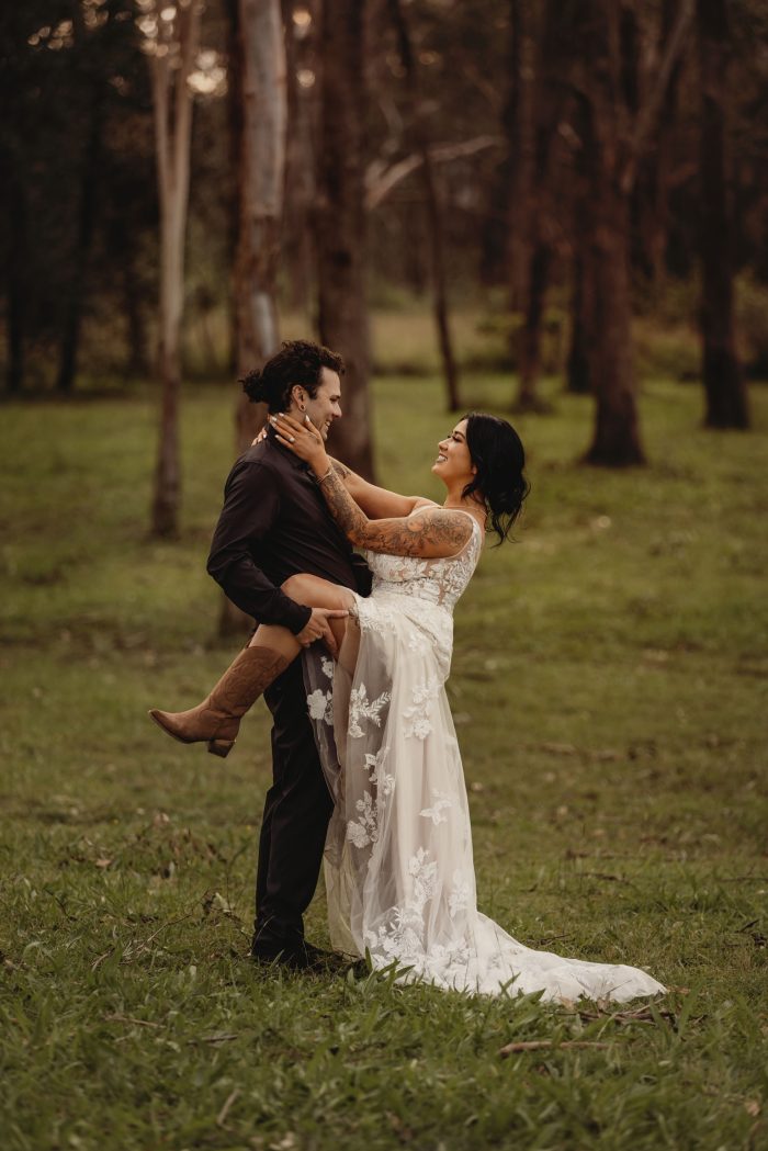 Bride wears boots as wedding shoes in Greenley Lane gown by Maggie Sottero