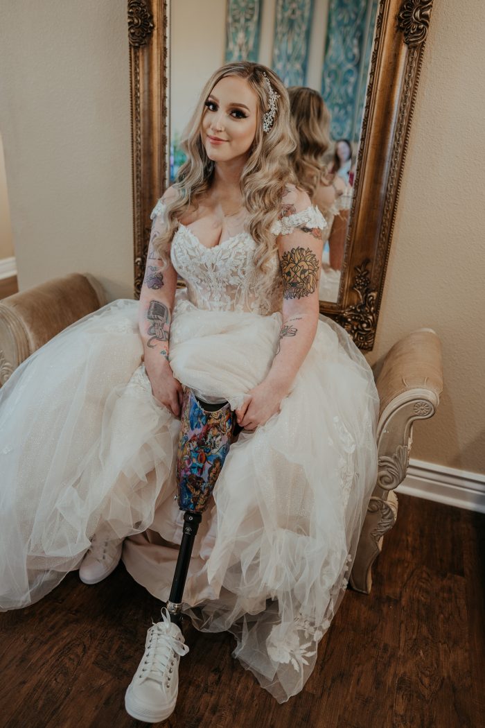 Bride wearing sneakers as wedding shoes in Harlem gown by Maggie Sottero