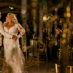 Bride Dancing with Groom Wearing Long Sleeve Wedding Dress Tuscany Royale by Maggie Sottero