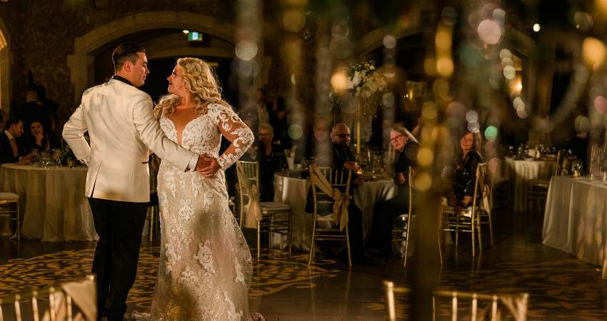 Bride Dancing with Groom Wearing Long Sleeve Wedding Dress Tuscany Royale by Maggie Sottero