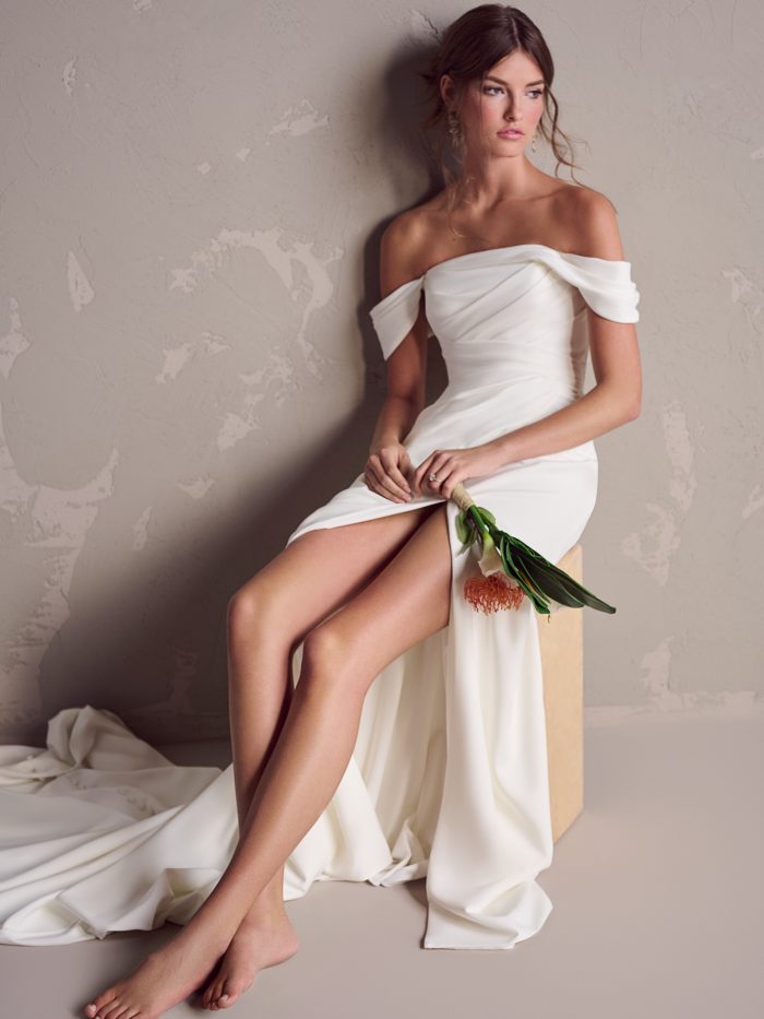 Bride Sitting with Bouquet in Lower Impact Sheath Bridal Dress Summer by Maggie Sottero