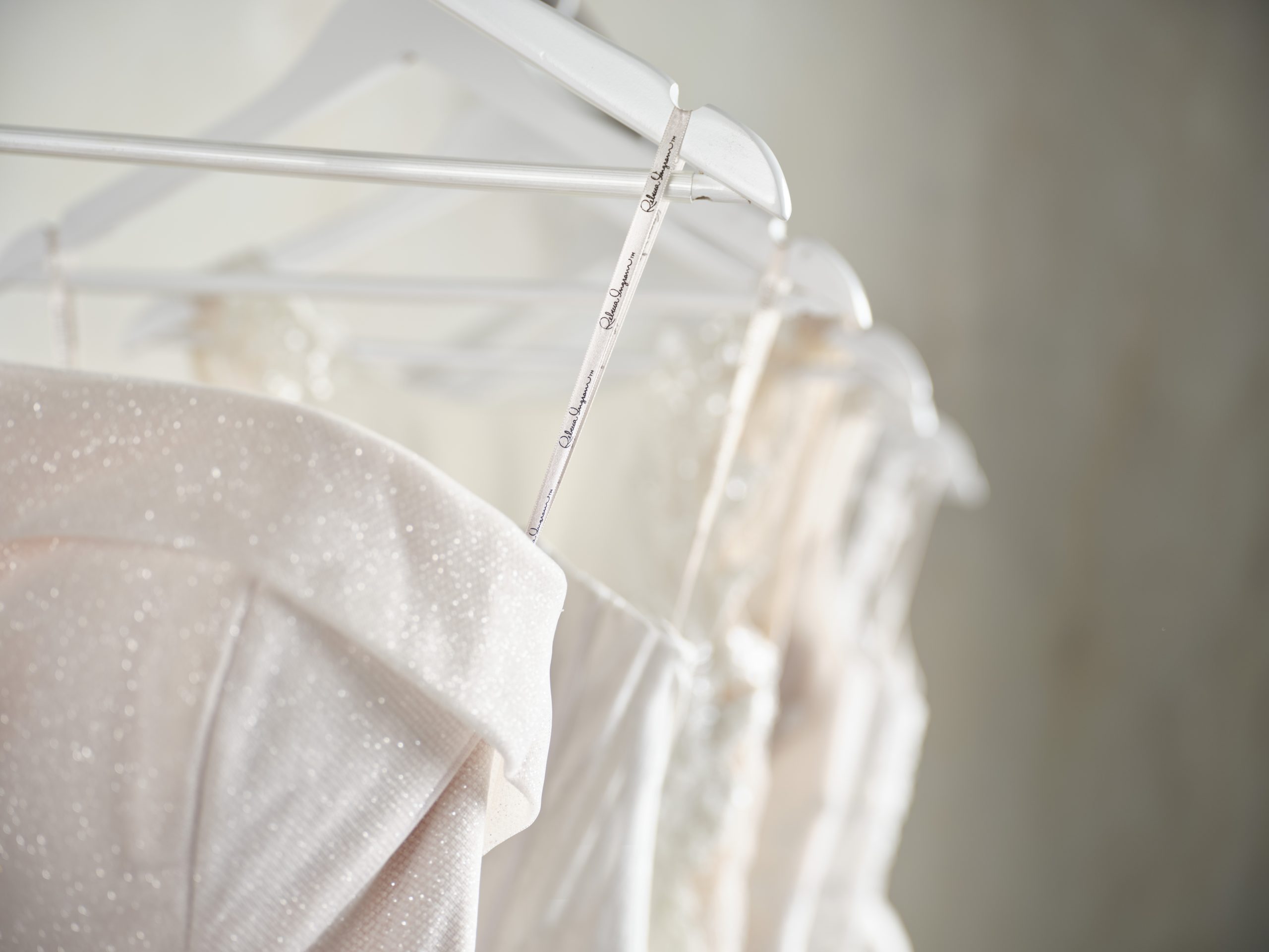 Maggie Sottero wedding dresses hanging on a rack