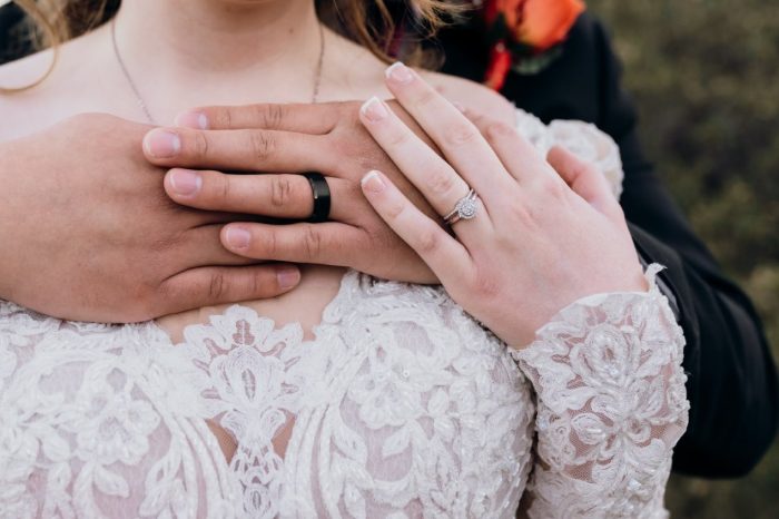 Groom and Bride wearing Hamilton gown by Sottero and Midgely and her wedding and engagement rings 