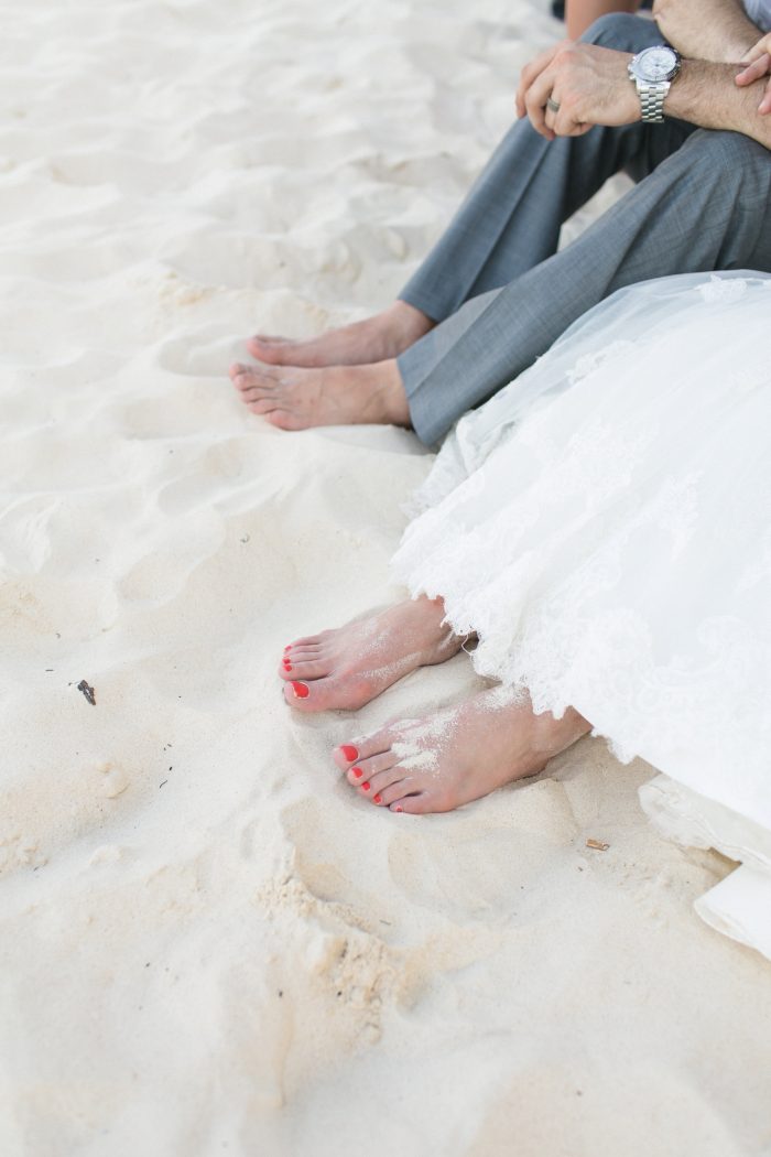 Couple with their feet in the sand at the beach