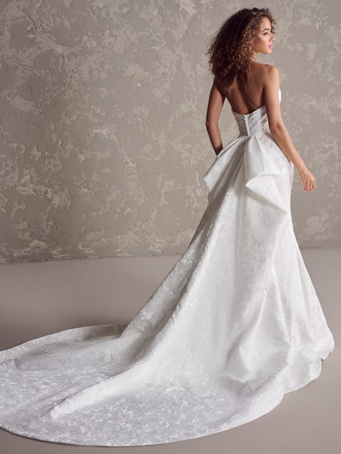 Model wearing wedding bow dress Hilo by Maggie Sottero