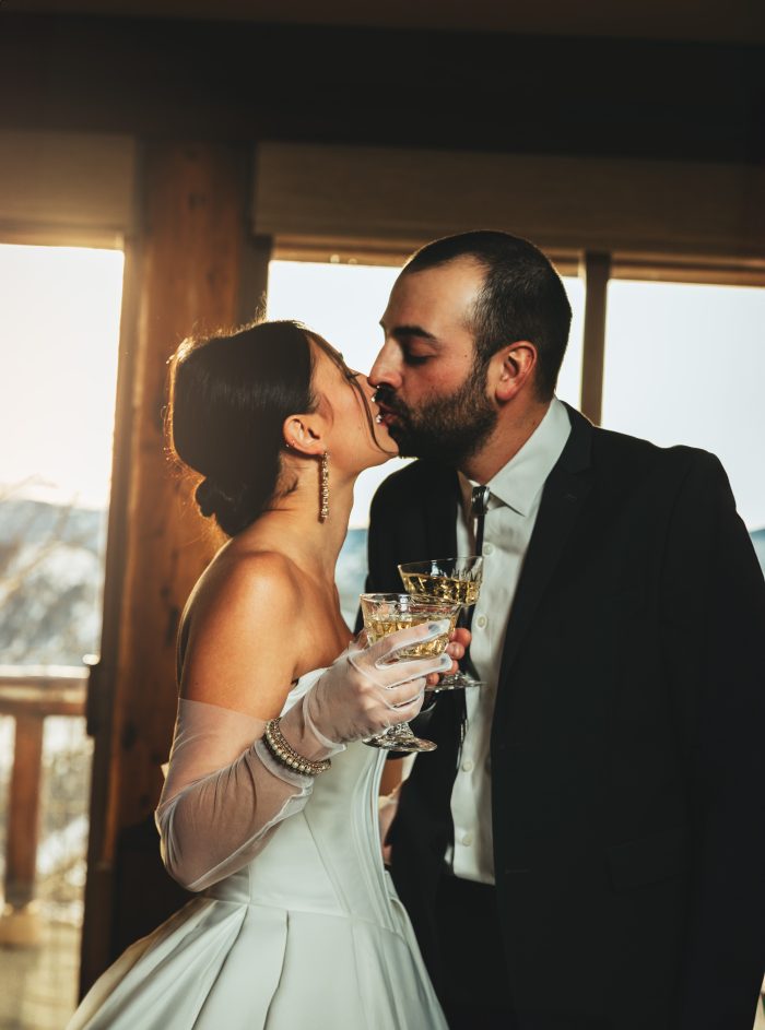 Bride wearing Derrick by Maggie Sottero in her winter wedding theme with her husband