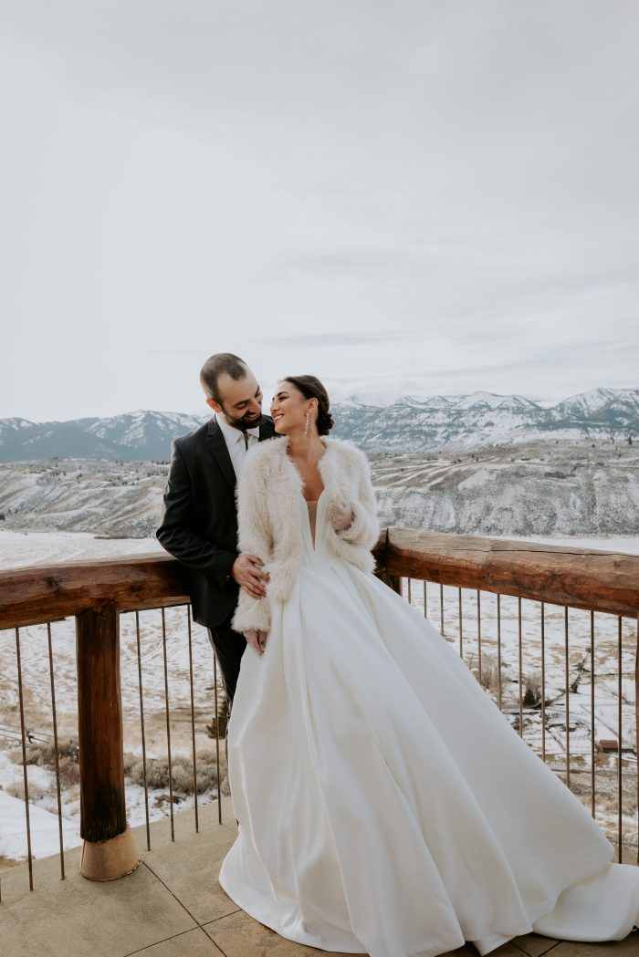 Bride wearing Derrick by Maggie Sottero in her winter wedding theme with her husband