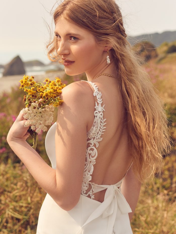 Model wearing wedding bow dress Emerald by Rebecca Ingram