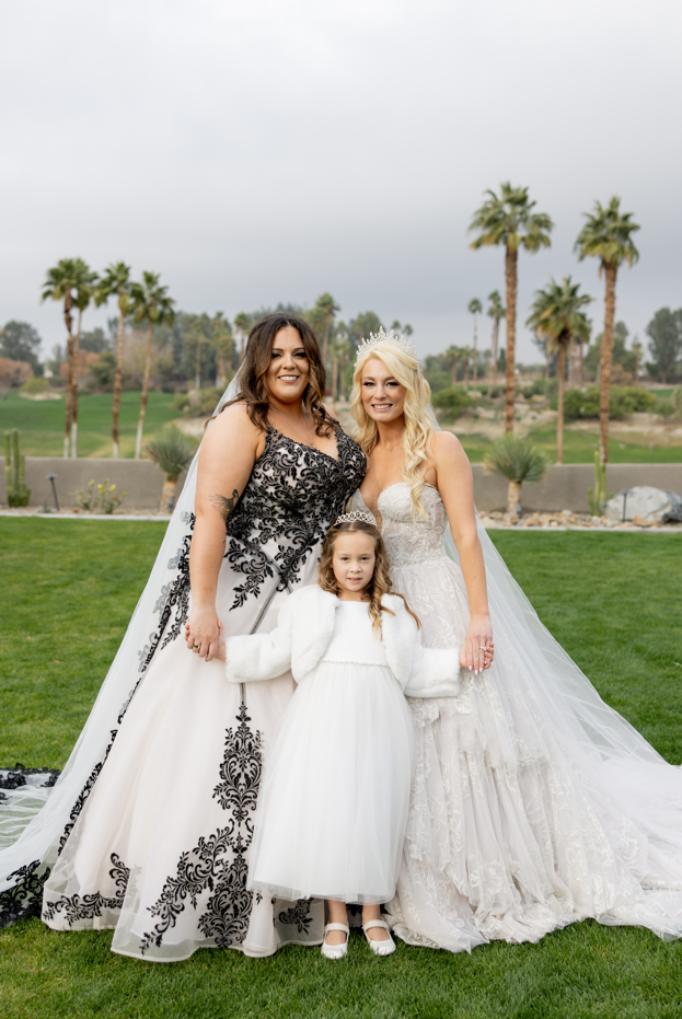 Brides Katie and Curly and their niece, wearing Tristyn wedding gown by Maggie Sottero, at their New Year's Eve wedding